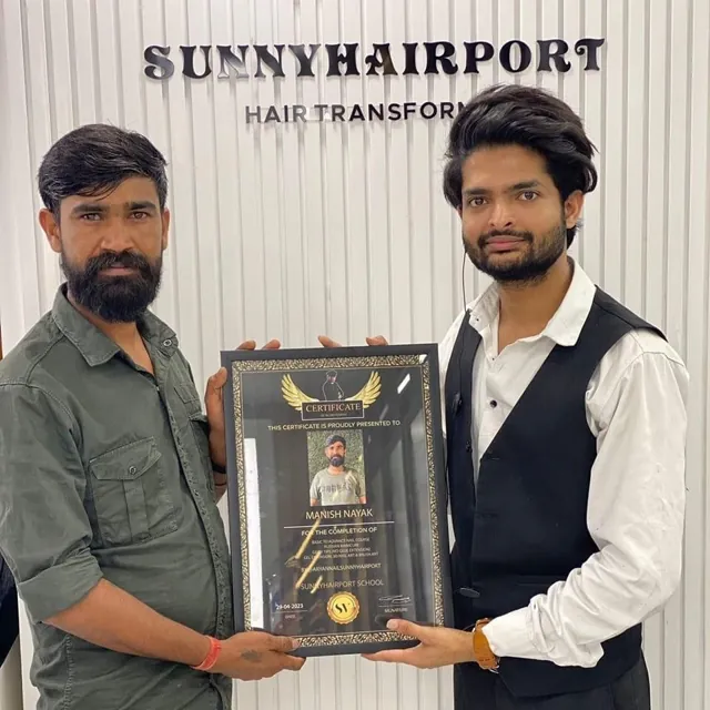 Team member receiving a certificate of achievement at a training school by Anand Mehendi & Tattoo, Bhubaneswar